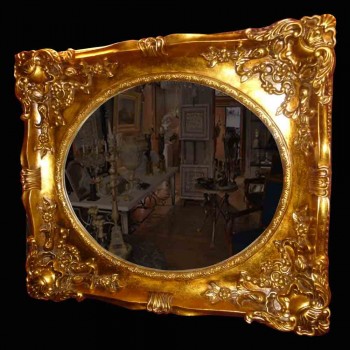Large oval Restoration-style mirror in wood and gilded stucco decorated with shells and foliage